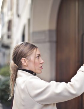 young-woman-presses-button-intercom